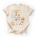 Flat lay of a natural Baking shirt with tools and desserts saying ill be in my office perfect gift for bakers and home baking lovers on a white background