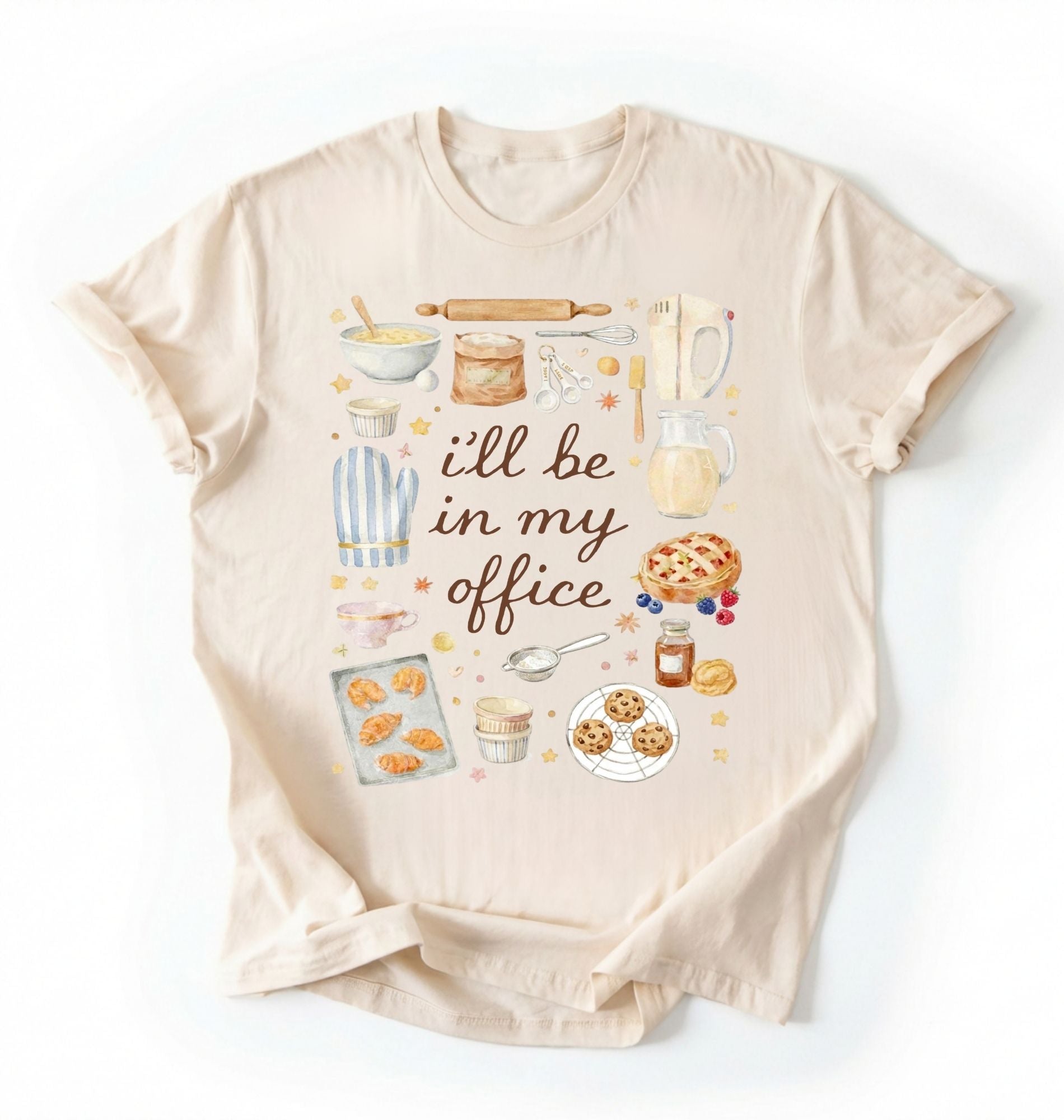 Flat lay of a natural Baking shirt with tools and desserts saying ill be in my office perfect gift for bakers and home baking lovers on a white background