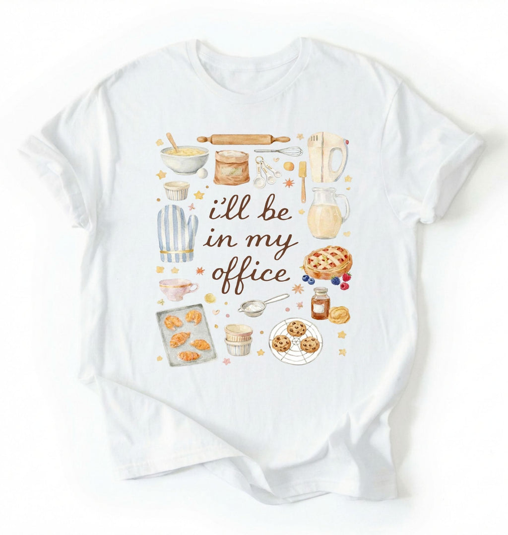 Flat lay of a white Baking shirt with tools and desserts saying ill be in my office perfect gift for bakers and home baking lovers on a white background