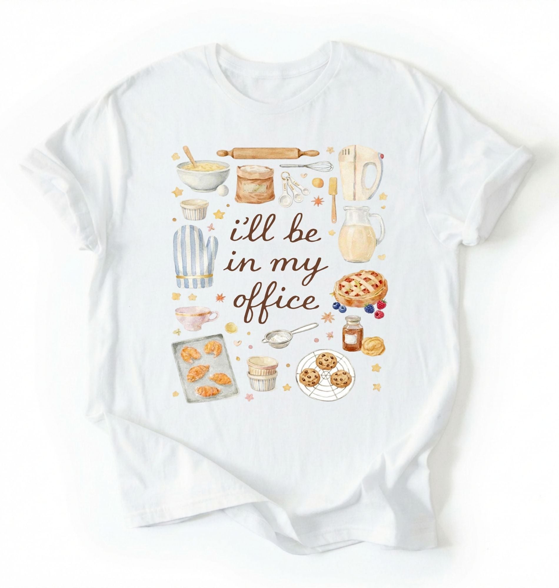 Flat lay of a white Baking shirt with tools and desserts saying ill be in my office perfect gift for bakers and home baking lovers on a white background