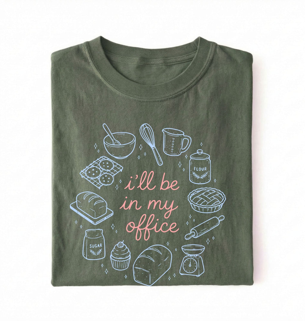Flat lay of a Funny baking shirt with bread pie cupcake and baking tools illustration on green tee on a white background 