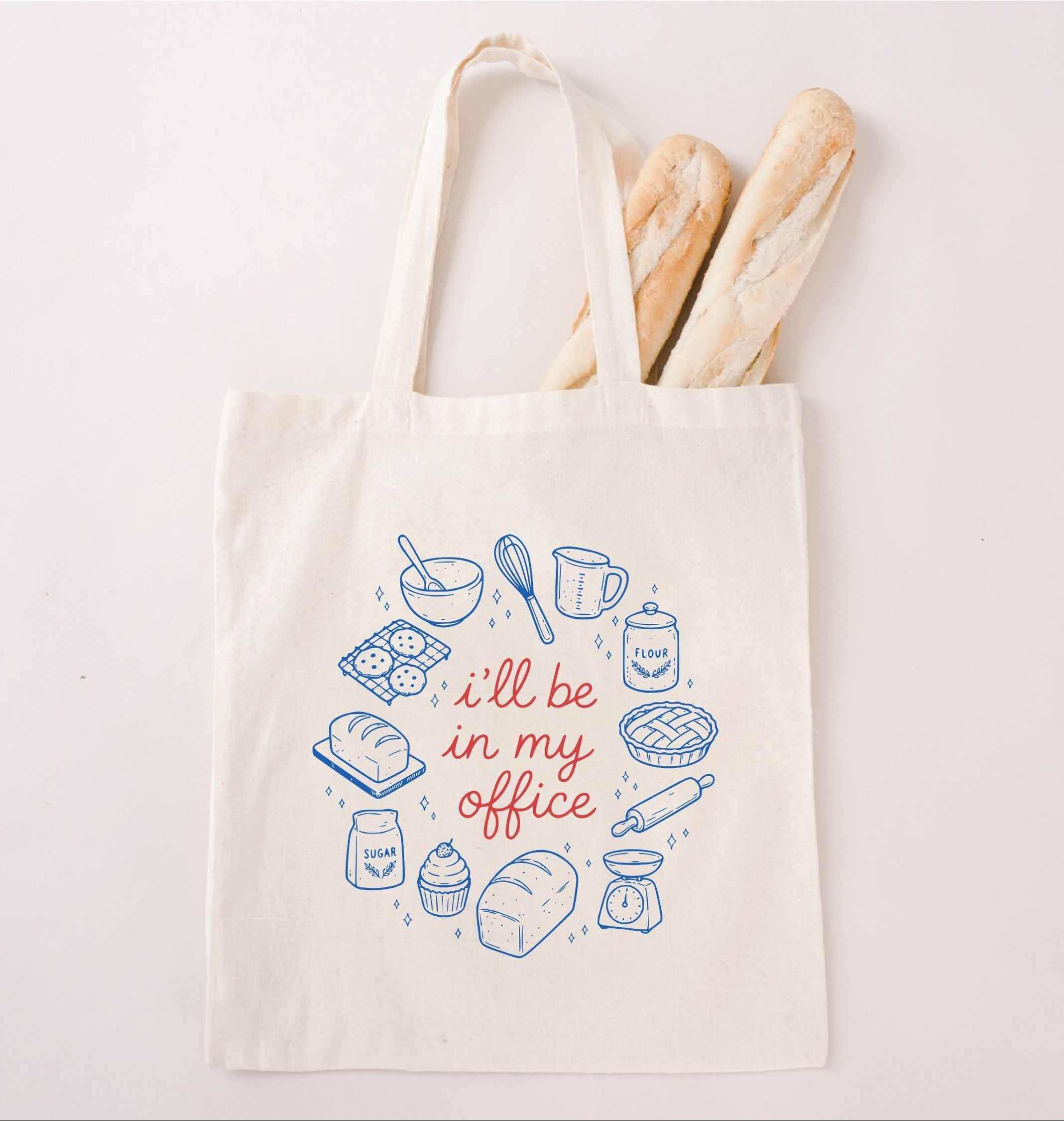 Reusable canvas tote featuring bread, baking ingredients, and kitchen tools