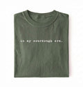 Flat lay of a moss Funny in my sourdough era baking shirt perfect for bread lovers home bakers and cozy kitchen aesthetic on a white background