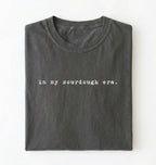 Flat lay of a pepper Funny in my sourdough era baking shirt perfect for bread lovers home bakers and cozy kitchen aesthetic on a white background
