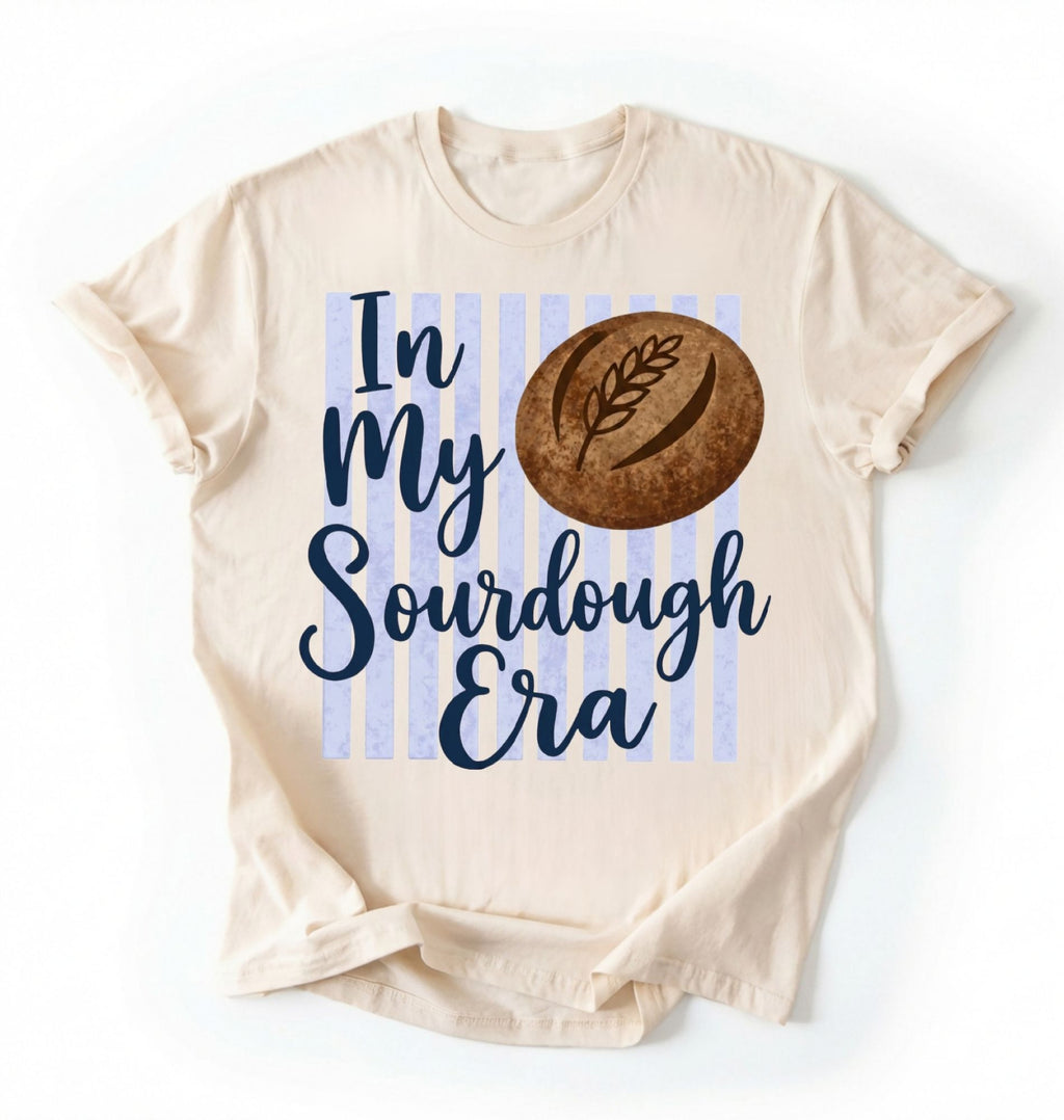 Flat lay of a natural in my sourdough era shirt white funny baking t shirt bread lover gift cottagecore style on a white background