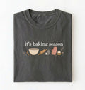 Flat lay of a pepper its baking season shirt with baking tools cupcake and oven mitt cute baker gift on a white background 