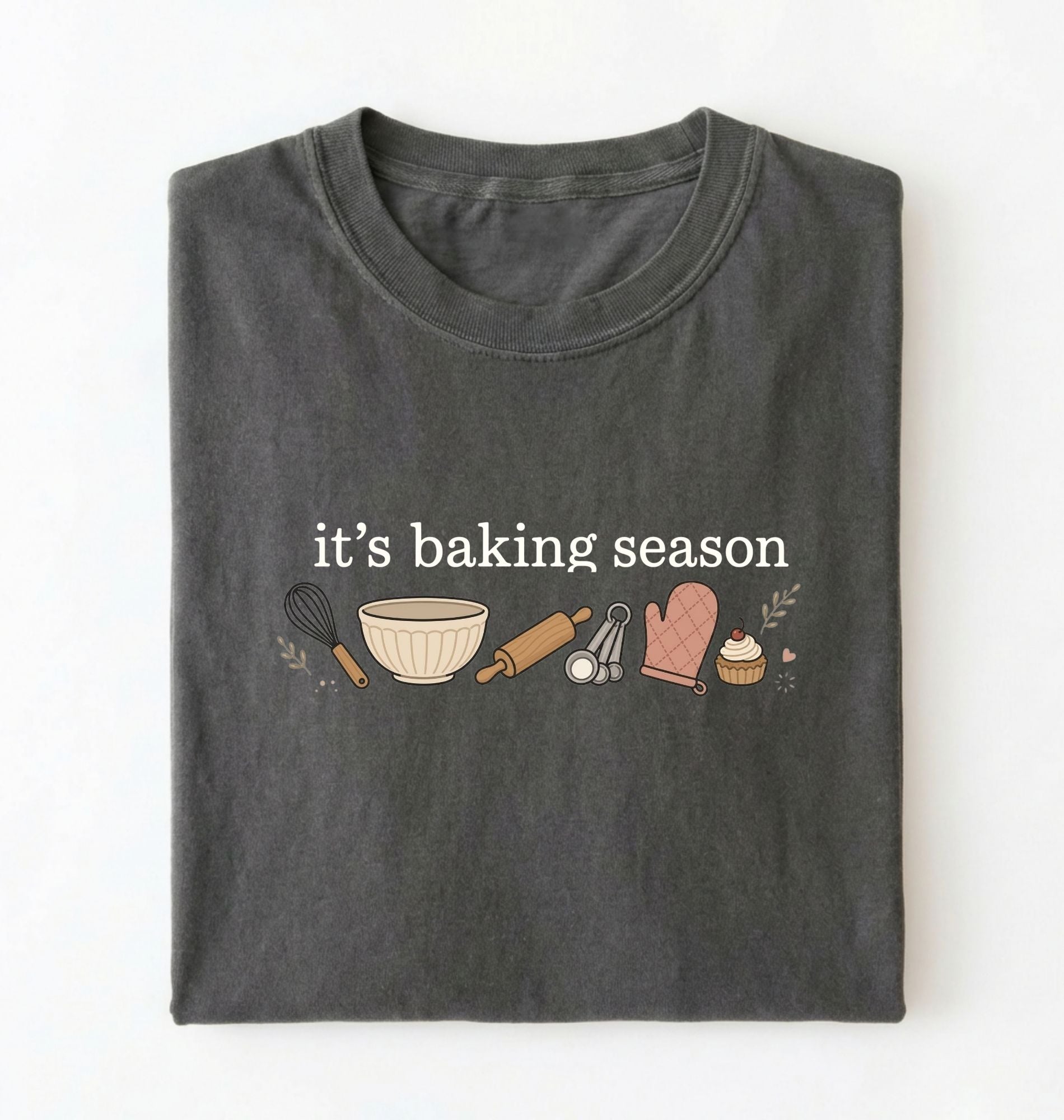 Flat lay of a pepper its baking season shirt with baking tools cupcake and oven mitt cute baker gift on a white background 