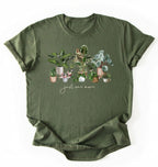 Flat lay of Military Green t-shirt with plant illustrations and 'just one more' text on a white background