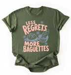 Flat lay of a green less regrets more baguettes shirt brown funny baking t shirt bread lover gift foodie humor design on a white background 