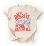 Flat lay of a ivory less regrets more baguettes shirt brown funny baking t shirt bread lover gift foodie humor design on a white background 