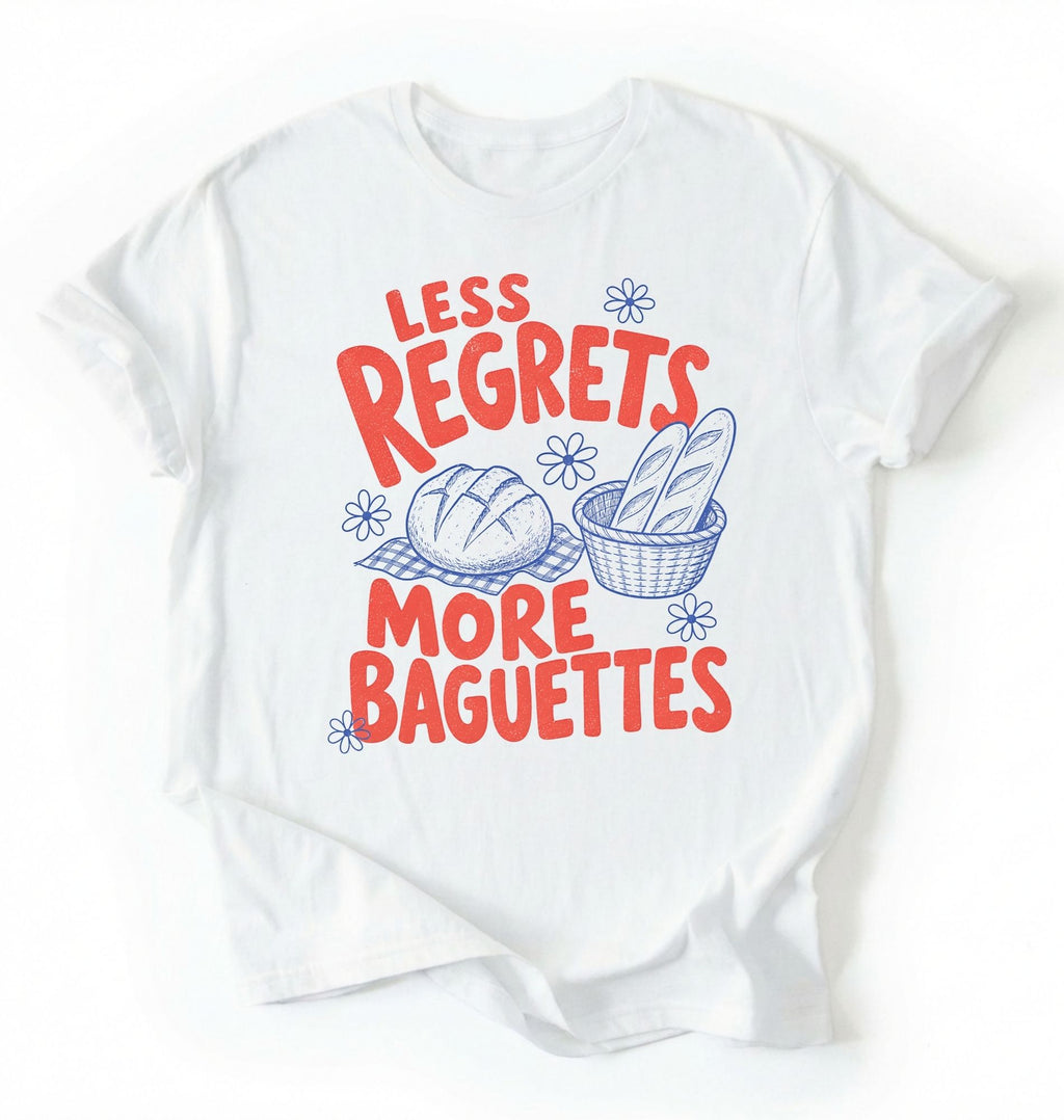 Flat lay of a white less regrets more baguettes shirt brown funny baking t shirt bread lover gift foodie humor design on a white background 