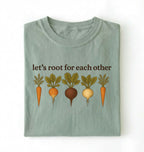 Flat lay of a bay t shirt with the text Let’s root for each other gardening t-shirt with illustrated root vegetables, perfect gardener gift on a white background