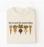 Flat lay of an ivory t shirt with the text Let’s root for each other gardening t-shirt with illustrated root vegetables, perfect gardener gift on a white background