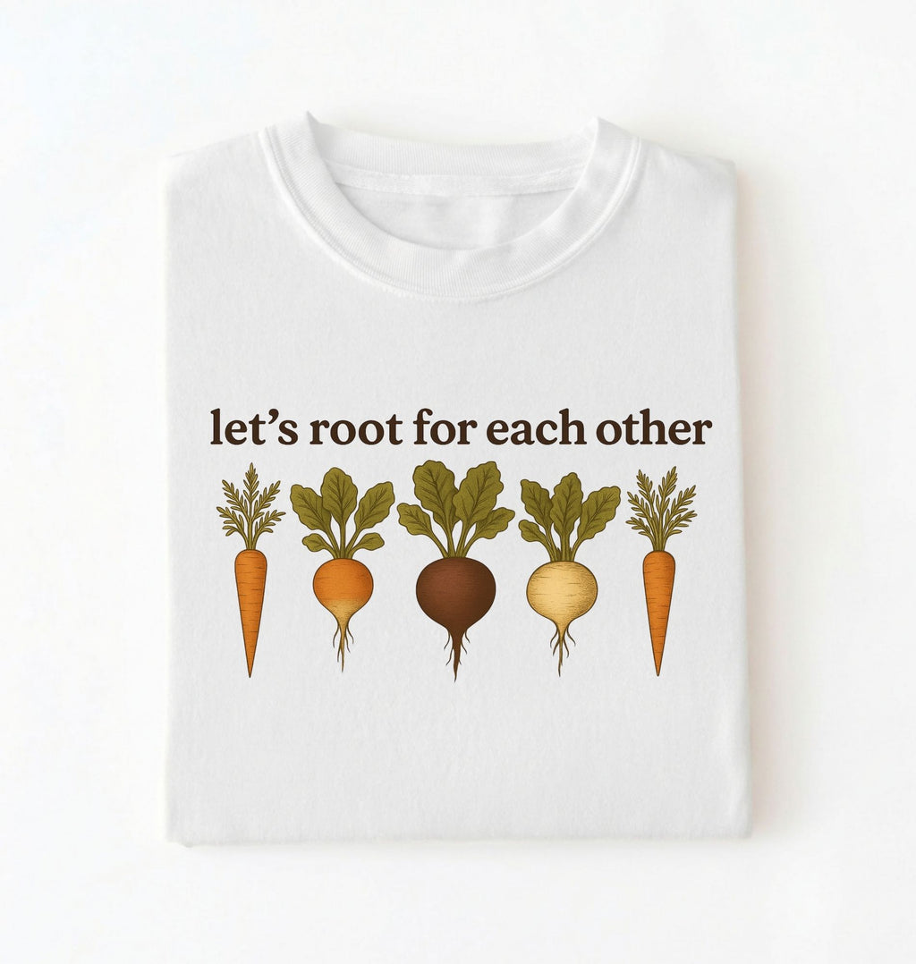 Flat lay of a white t shirt with the text Let’s root for each other gardening t-shirt with illustrated root vegetables, perfect gardener gift on a white background 