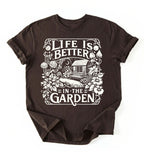 Flat lay of a dark_chocolate shirt written Life is better in the garden cottagecore t-shirt with vintage floral garden illustration, perfect gardener gift on a white background