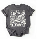Flat lay of a Charcoal shirt written Life is better in the garden cottagecore t-shirt with vintage floral garden illustration, perfect gardener gift on a white background