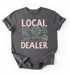 Flat lay of a Charcoal Funny local dealer bread shirt with baking tools and sourdough theme perfect gift for bakers and bread lovers on a white background 