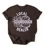 Flat lay of a dark chocolate local sourdough dealer shirt brown funny baking t shirt bread lover gift bakery humor on a white background 