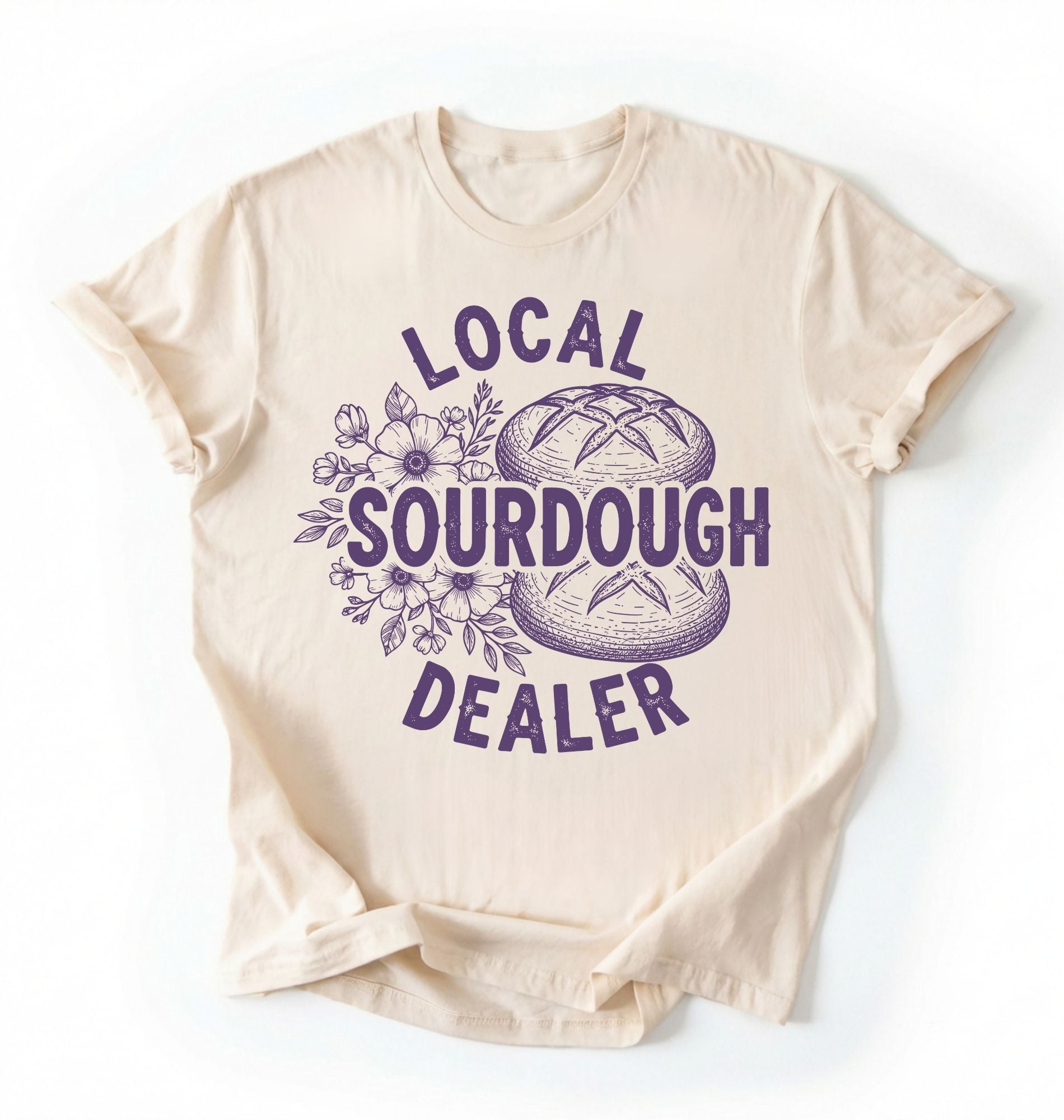 Flat lay of an ivory local sourdough dealer shirt brown funny baking t shirt bread lover gift bakery humor on a white background 