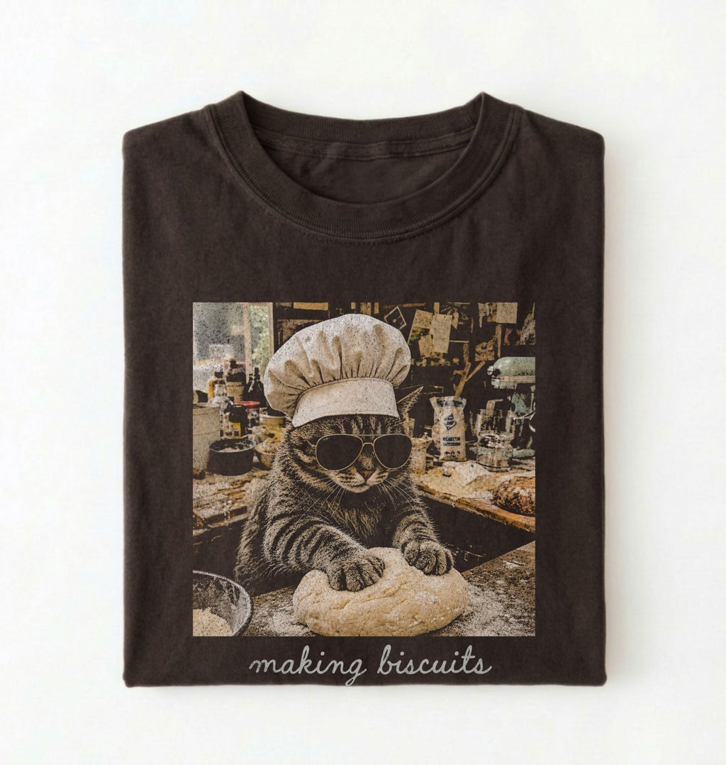 Flat lay of a brown making biscuits cat shirt with chef cat kneading dough funny baker and cat lover gift on a white background 