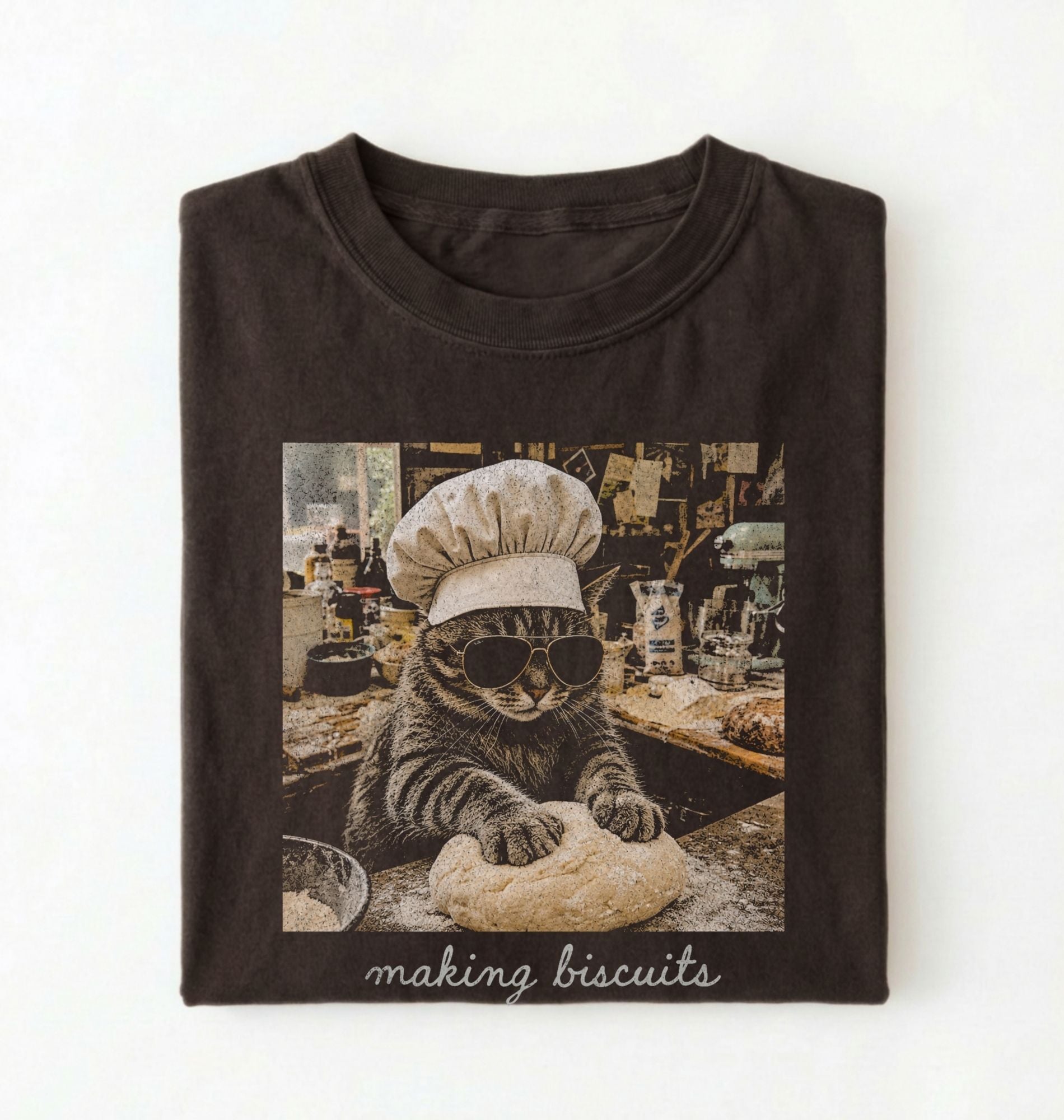 Flat lay of a brown making biscuits cat shirt with chef cat kneading dough funny baker and cat lover gift on a white background 