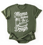 Flay lay of a green Mama makes the dough shirt with bread and jar illustration funny baking mom gift white t-shirt on a white background