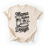 Flay lay of a green Mama makes the dough shirt with bread and jar illustration funny baking mom gift white t-shirt on a white background