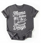Flay lay of a charcoal Mama makes the dough shirt with bread and jar illustration funny baking mom gift white t-shirt on a white background