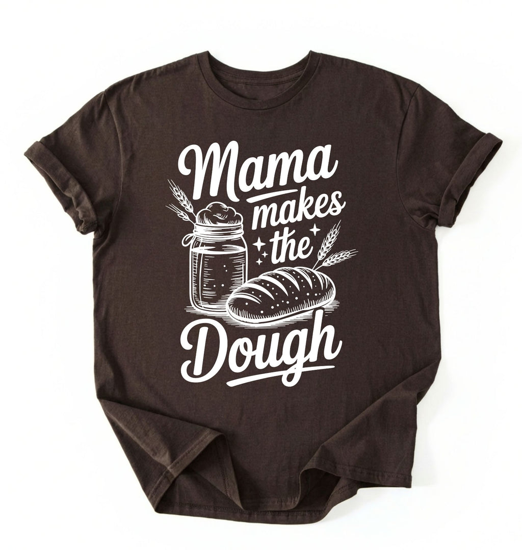 Flay lay of a dark chocolate Mama makes the dough shirt with bread and jar illustration funny baking mom gift white t-shirt on a white background