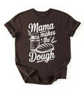 Flay lay of a dark chocolate Mama makes the dough shirt with bread and jar illustration funny baking mom gift white t-shirt on a white background