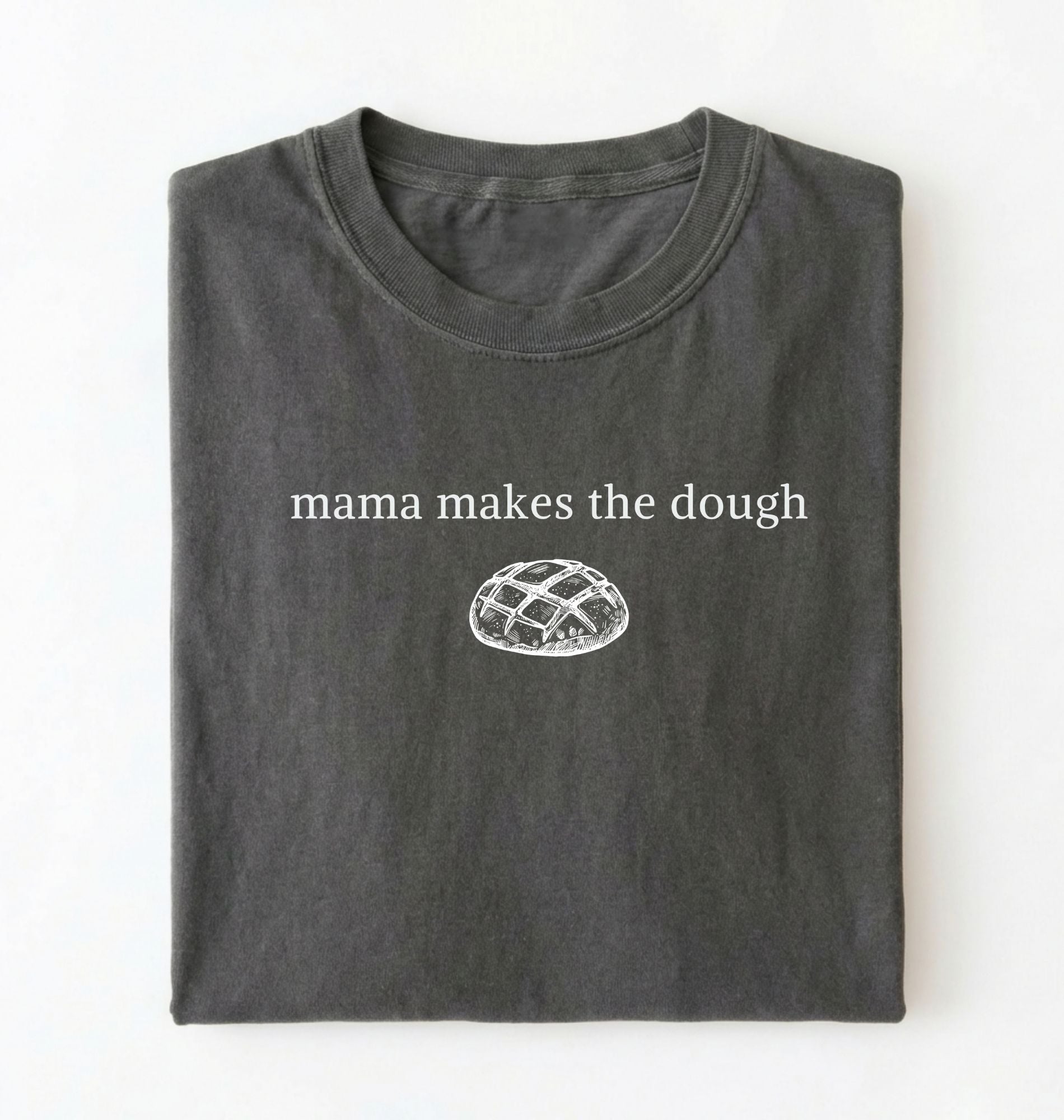Flat lay of a military green Funny Mama Makes The Dough shirt with bread graphic on brown tee on a white background