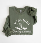 Flat lay of a military green Gildan sweatshirt featuring a rolling pin, whisk and mixing bowl with the phrase Midnight Baking Society on a white background