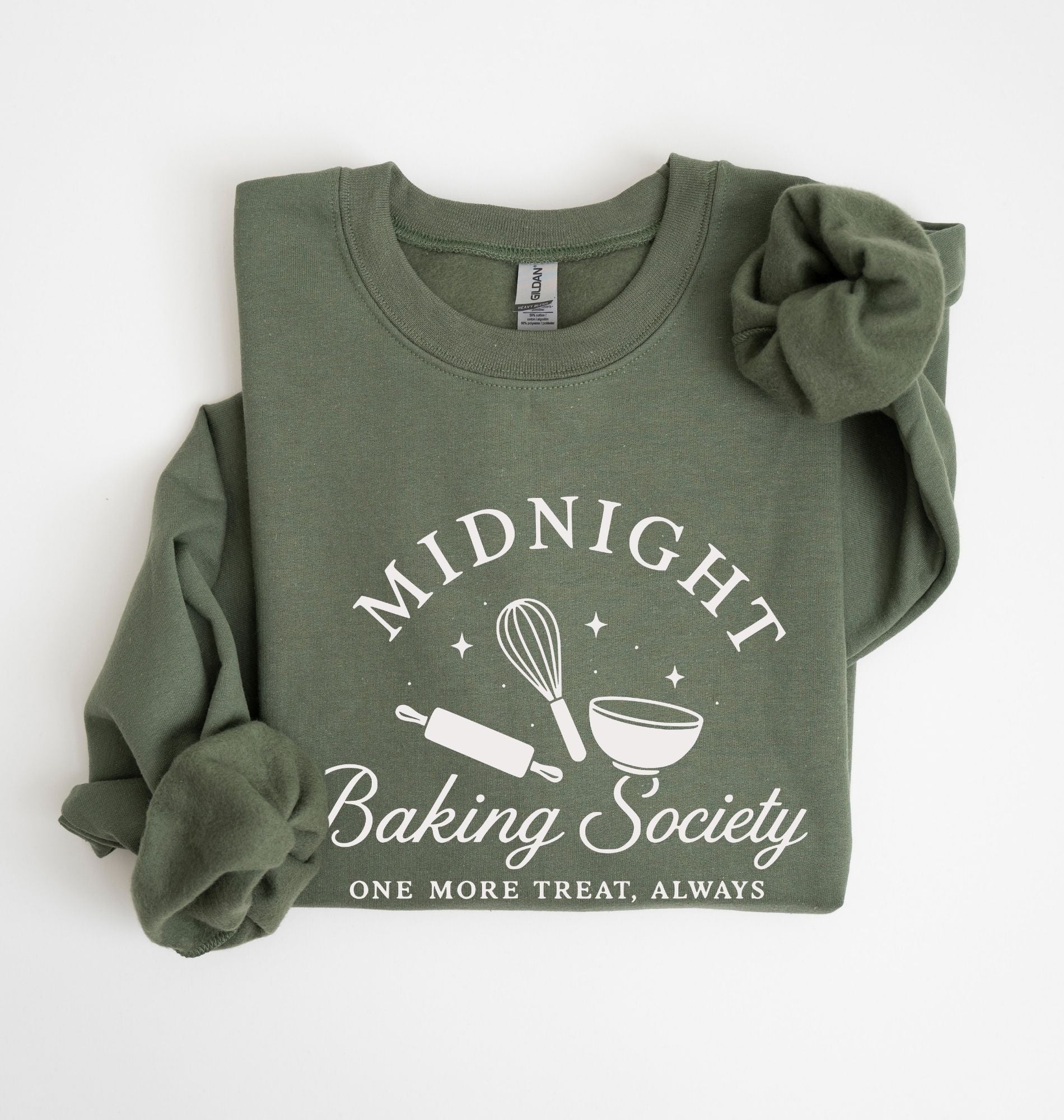 Flat lay of a military green Gildan sweatshirt featuring a rolling pin, whisk and mixing bowl with the phrase Midnight Baking Society on a white background