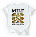 Flat lay of a white Funny MILF frog shirt with illustrated frogs and Man I Love Frogs text graphic tee on a white background 