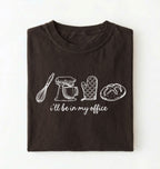 Flat lay of a dark chocolate Minimalist baking shirt with kitchen tools line art and ill be in my office text perfect gift for bakers on a white background 