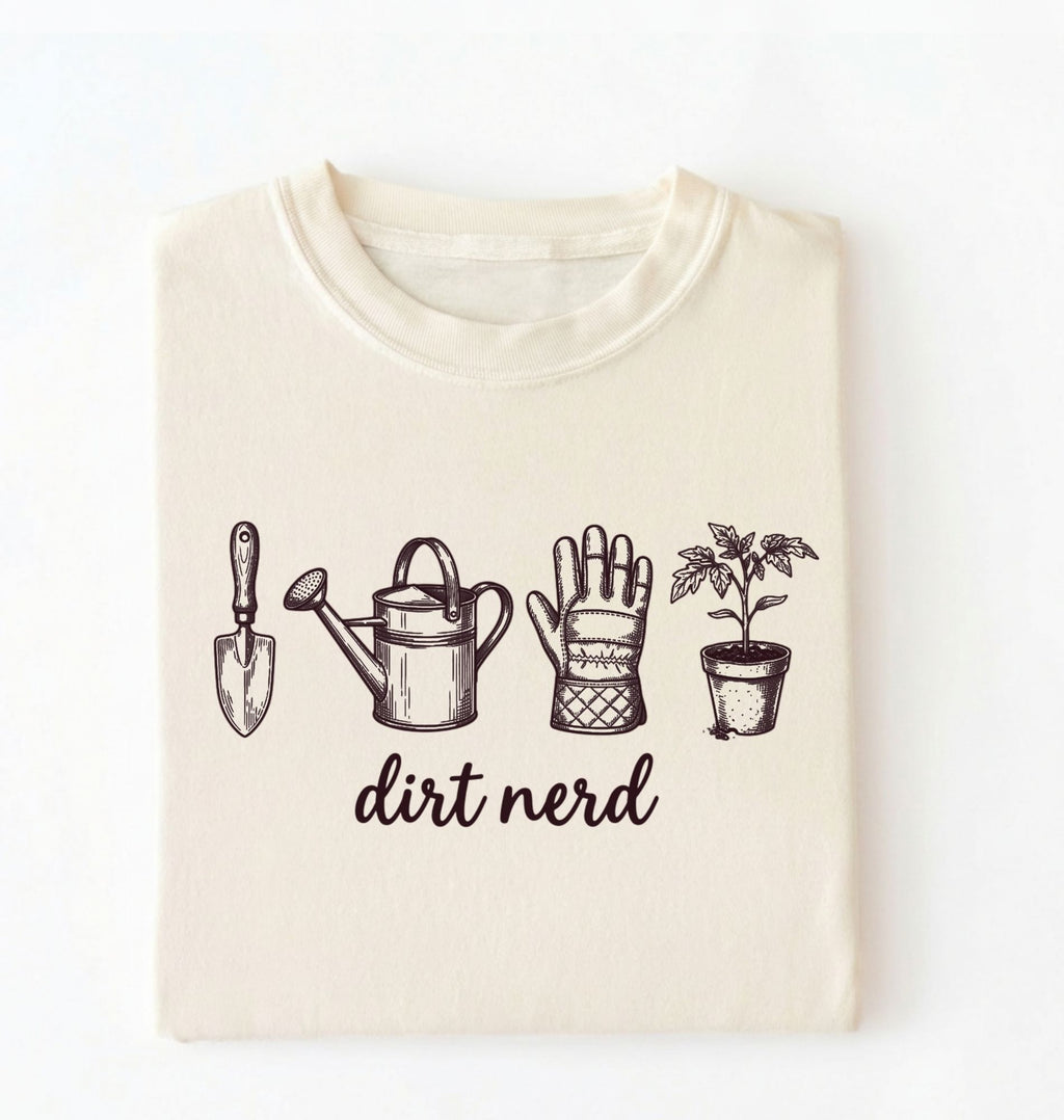 Flat lay of an ivory Minimalist dirt nerd shirt with garden tools design perfect gift for plant lovers and gardeners on a white background 