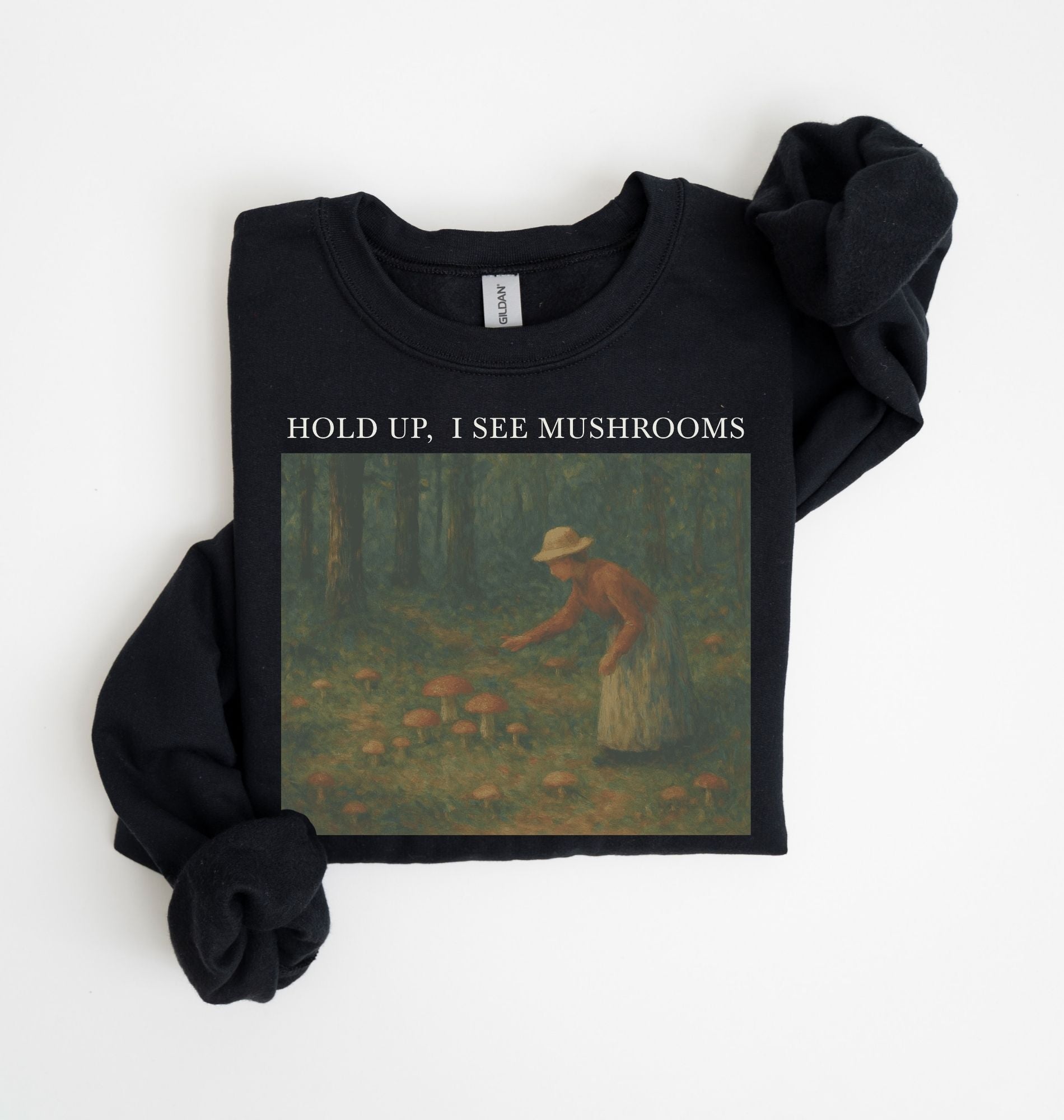 Flat lay of an black Cottagecore mushroom sweatshirt Hold Up I See Mushrooms design beige crewneck for nature lovers on a white background