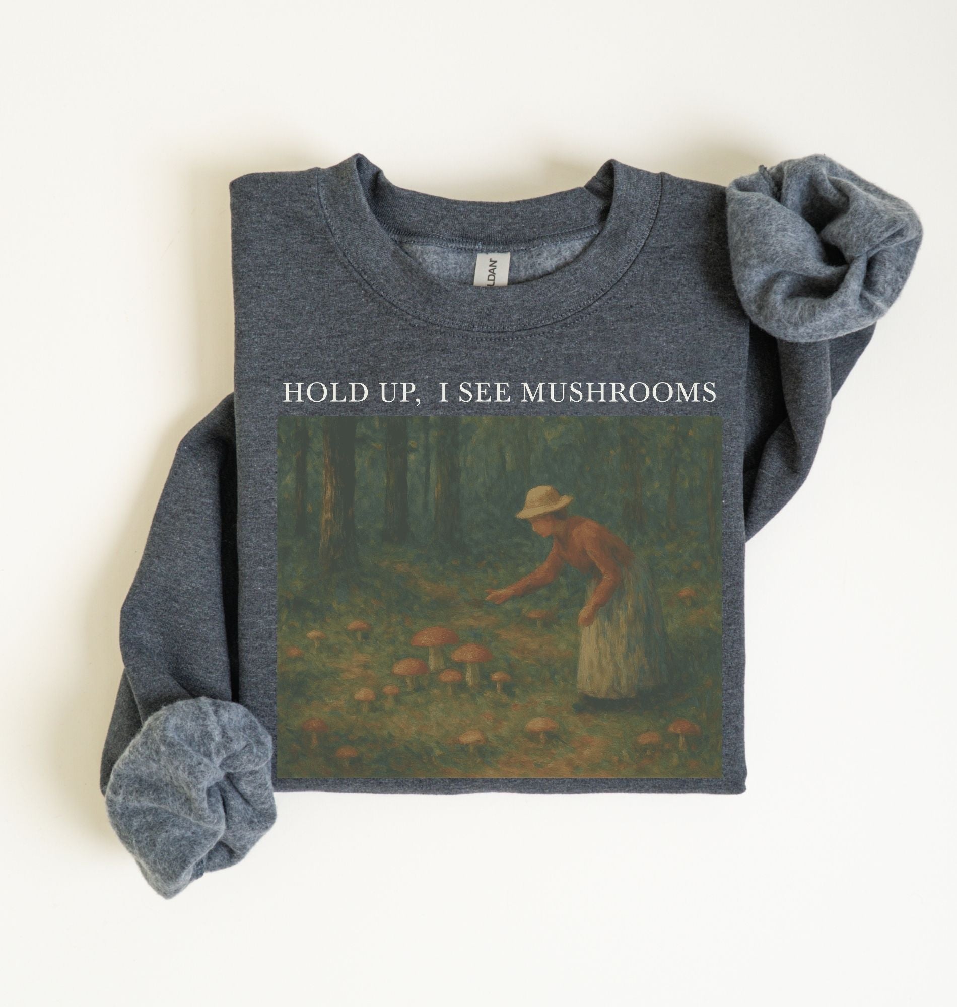 Flat lay of an dark heather Cottagecore mushroom sweatshirt Hold Up I See Mushrooms design beige crewneck for nature lovers on a white background