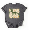 Flat lay of a Charcoal Gardener t-shirt with floral design and text my plants are thriving but i am not plant lover gift on a white background 