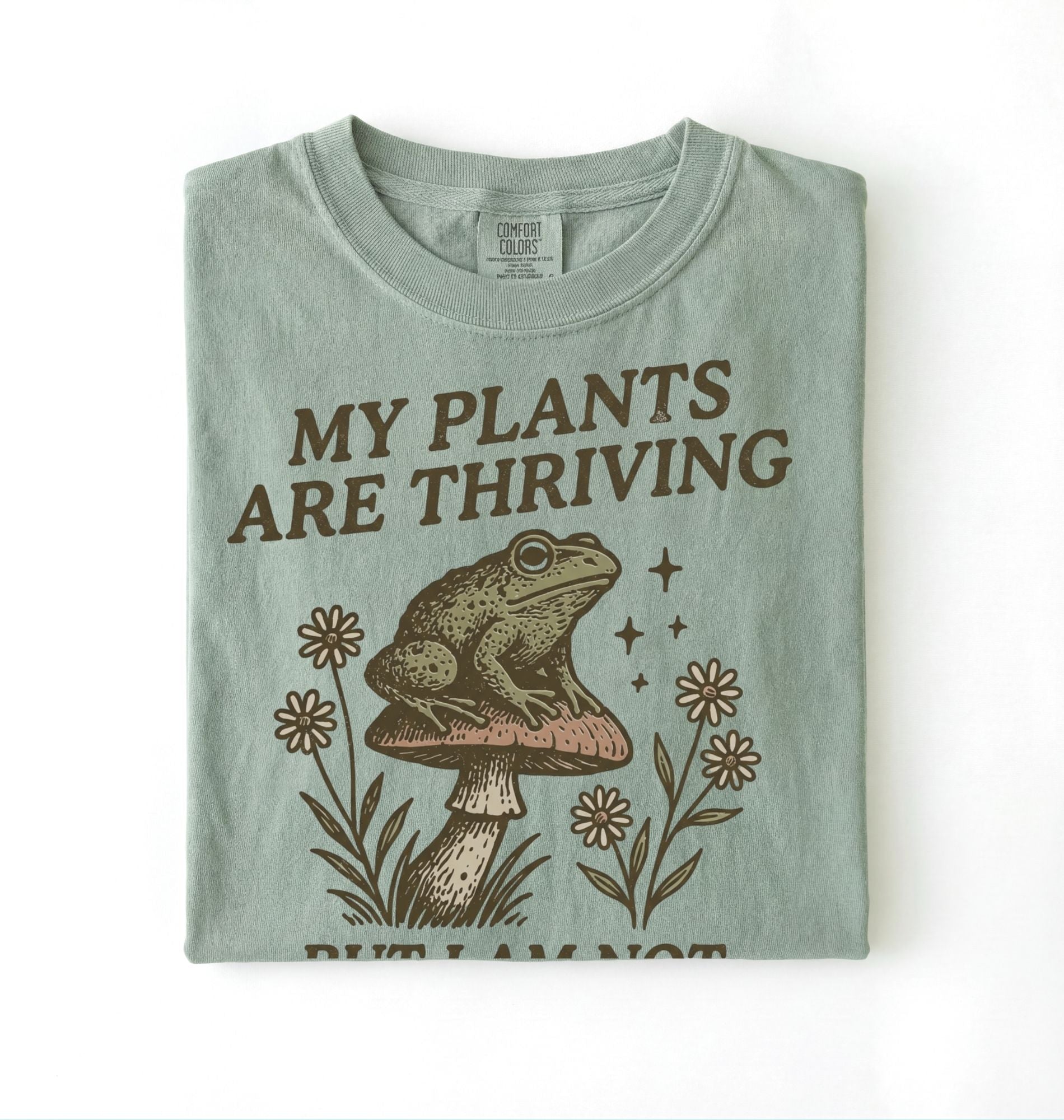 Bay Comfort Colors shirt with frog sitting on mushroom and text my plants are thriving but I am not