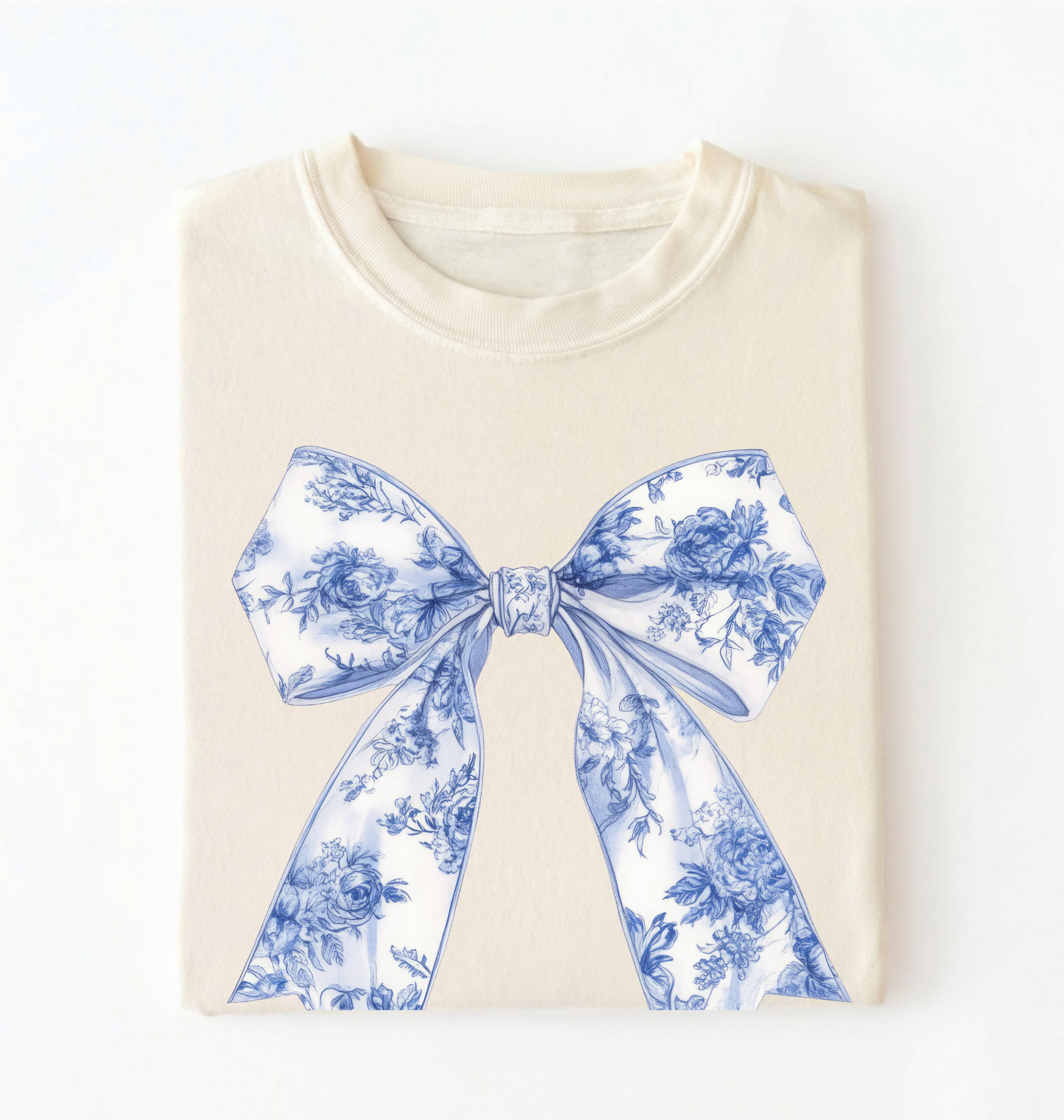 A natural-colored crewneck t-shirt with a detailed blue graphic print about bee pollination, featuring illustrations of a beehive, flowers, bees, and pollen transport, laid flat against a white background.