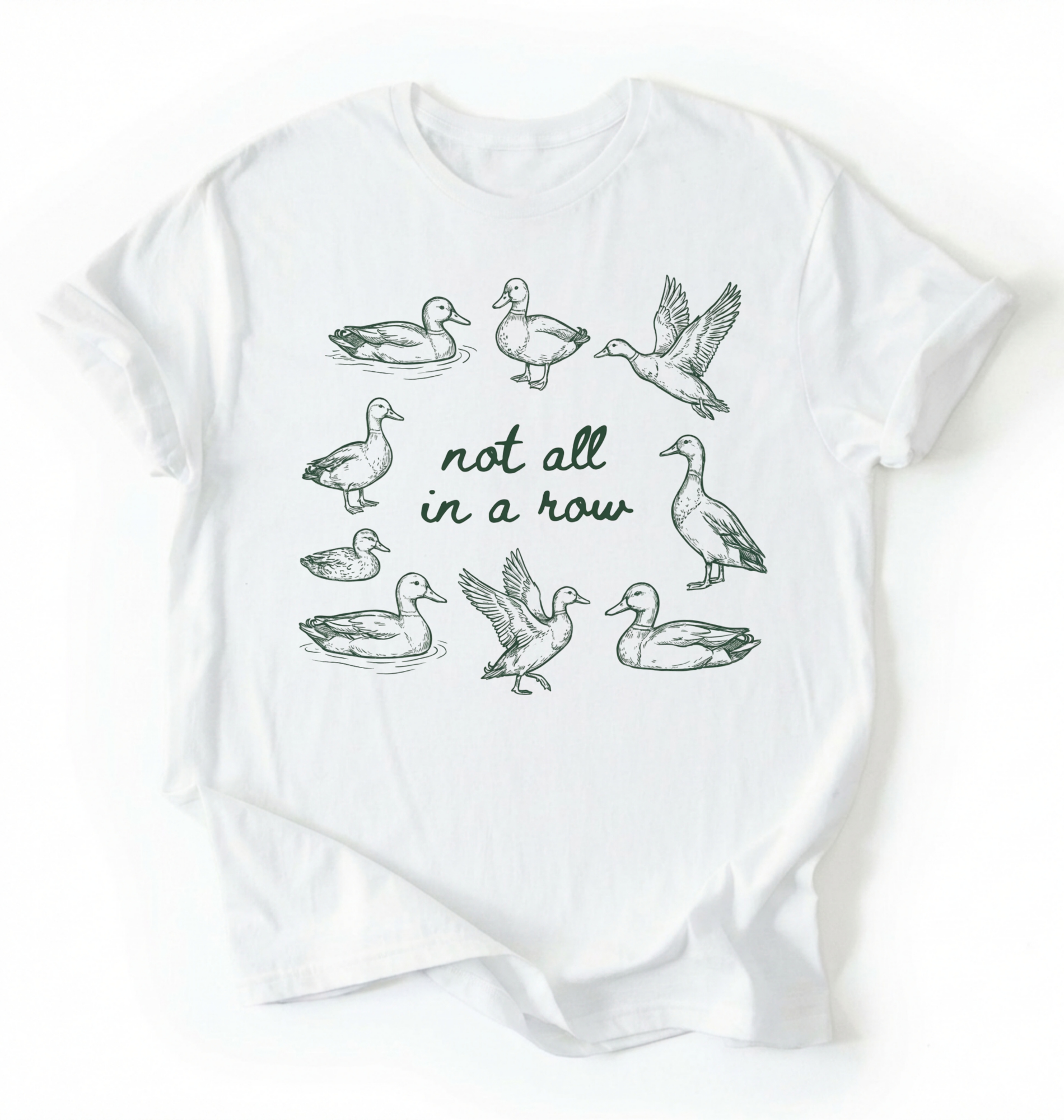 Flat lay of an bay duck graphic t-shirt with hand drawn ducks and not all in a row text, funny animal shirt gift on a white background 