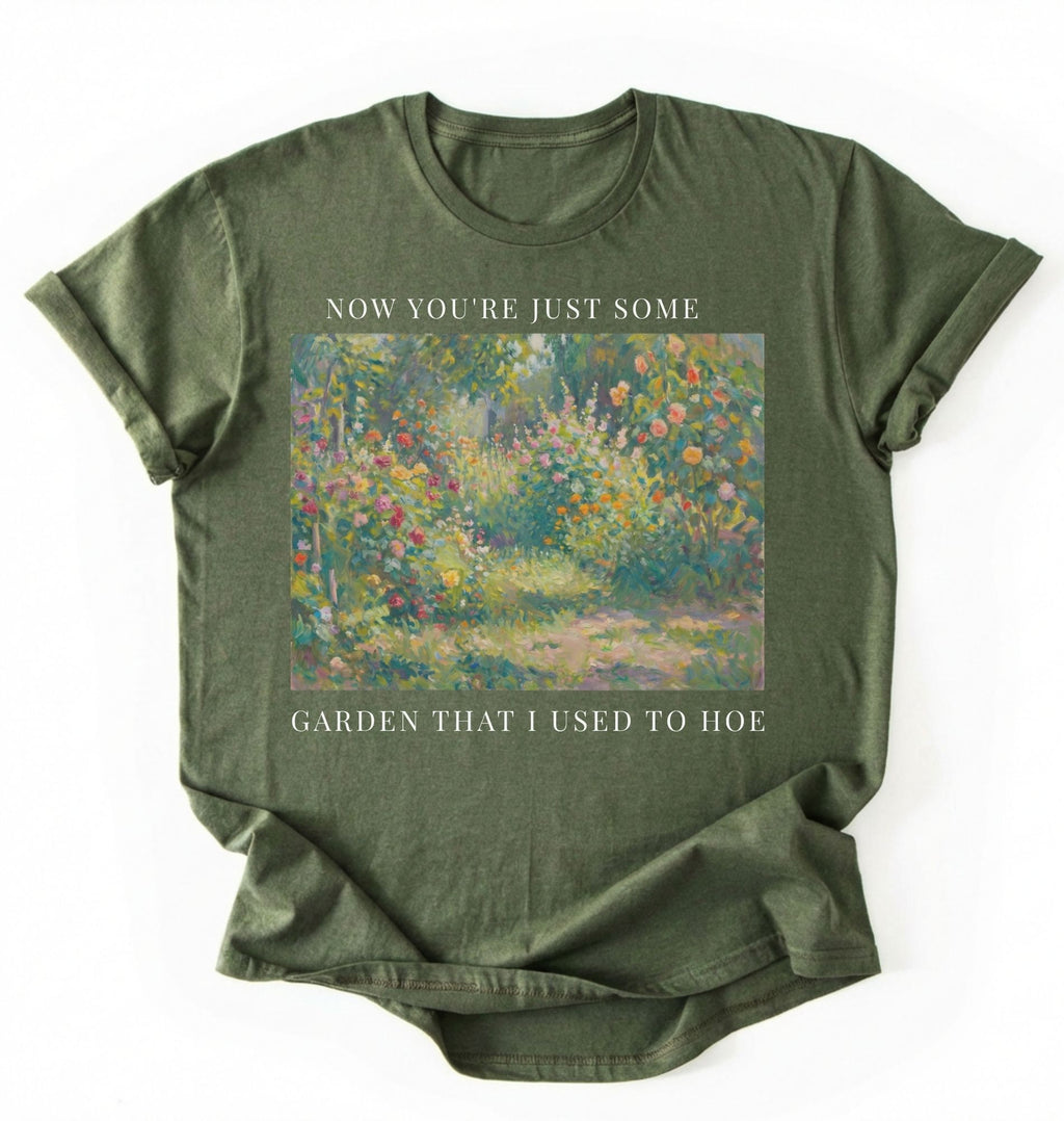 Flat lay of a green shirt written Now you’re just some garden t-shirt with funny gardening pun, perfect gardener gift on a white background
