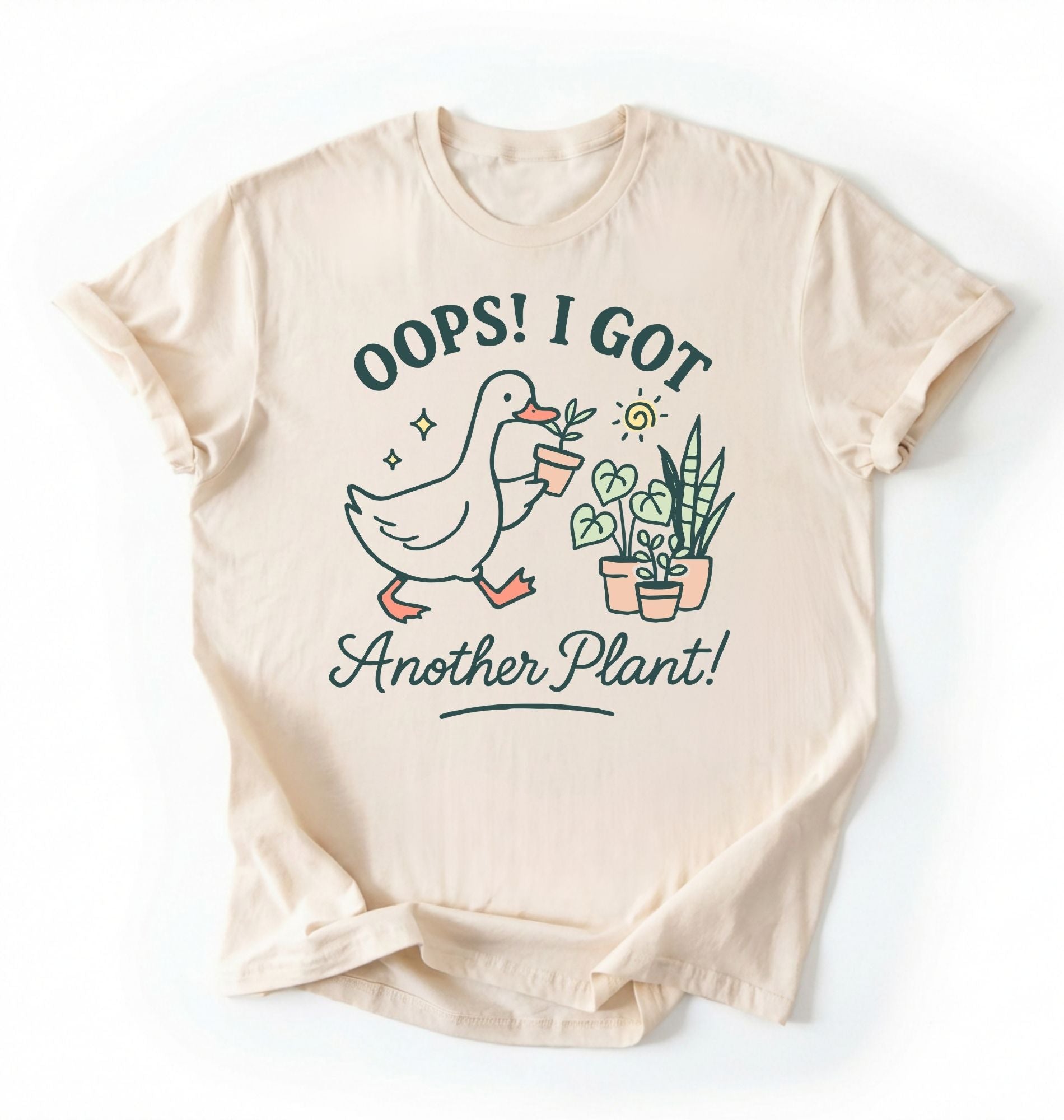 Flat lay natural t-shirt with a graphic of a duck holding a plant and text 'Oops! I got another plant!' on a white background