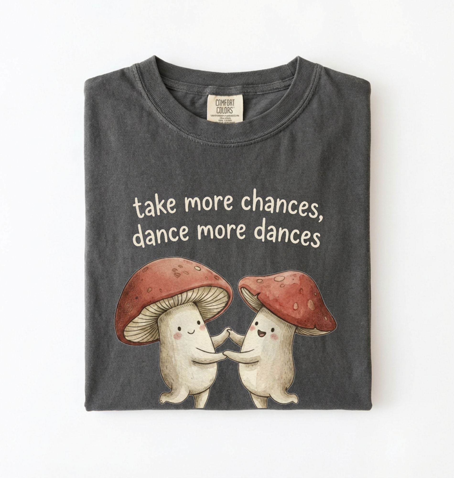 Pepper t-shirt with two dancing mushrooms and the phrase take more chances dance more dances, whimsical cottagecore gift tee