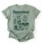 Flat lay of a Bay_Sage t-shirt featuring a botanical diagram with text reading “Photosynthesis Power Up.” for plant lovers and science fans perfect gardening gift for biology teachers and nature enthusiasts on a white background  