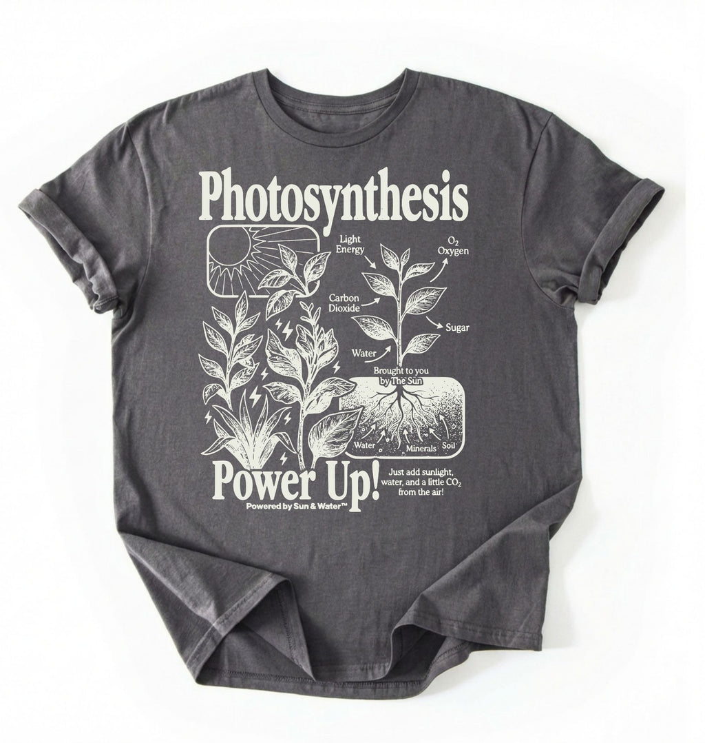 Flat lay of a Charcoal t-shirt featuring a botanical diagram with text reading “Photosynthesis Power Up.” for plant lovers and science fans perfect gardening gift for biology teachers and nature enthusiasts on a white background  