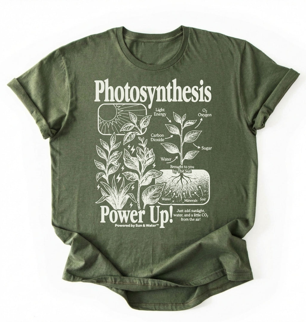Flat lay of a military green t-shirt featuring a botanical diagram with text reading “Photosynthesis Power Up.” for plant lovers and science fans perfect gardening gift for biology teachers and nature enthusiasts on a white background 