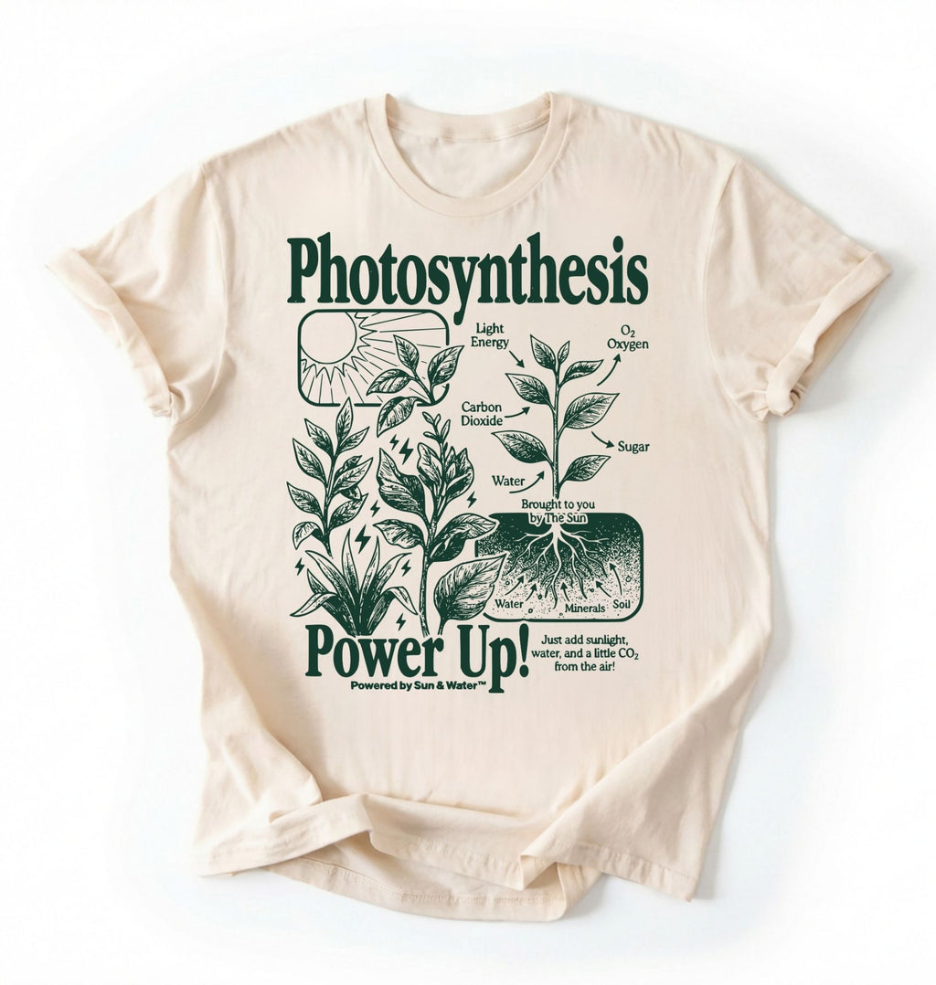 Flat lay of a natural t-shirt featuring a botanical diagram with text reading “Photosynthesis Power Up.” for plant lovers and science fans perfect gardening gift for biology teachers and nature enthusiasts on a white background  