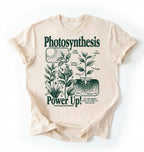 Flat lay of a natural t-shirt featuring a botanical diagram with text reading “Photosynthesis Power Up.” for plant lovers and science fans perfect gardening gift for biology teachers and nature enthusiasts on a white background  